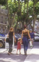 Trois mesdemoiselles promenading in the tree lined streets