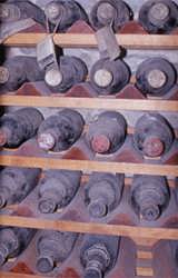 Fine bottles quietly performing their magic in the dust of a cellar dating back to Roman times
